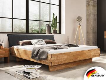 CORDINO Wangenbett aus Eiche mit Polsterkopfteil, Material Massivholz 