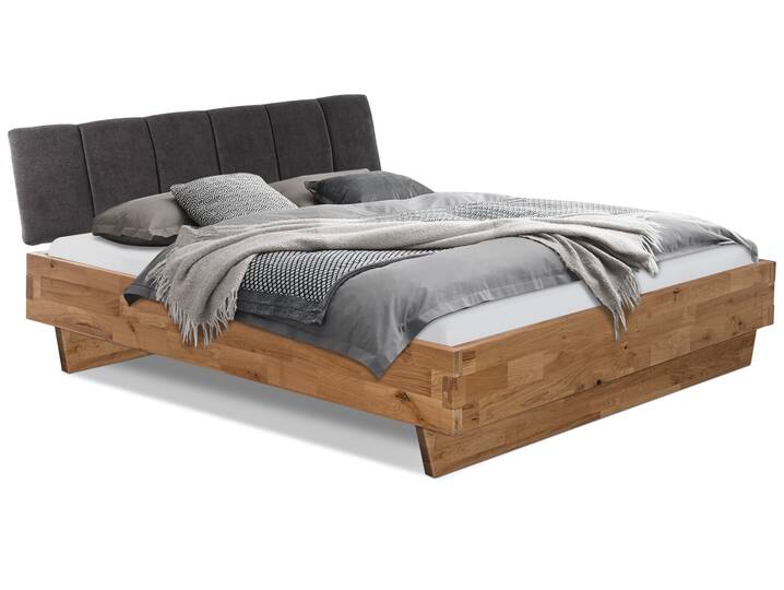 CORDINO Wangenbett aus Eiche mit Polsterkopfteil, Material Massivholz 180 x 220 cm | Eiche unbehandelt | Stoff Anthrazit mit Steppung | gebürstet